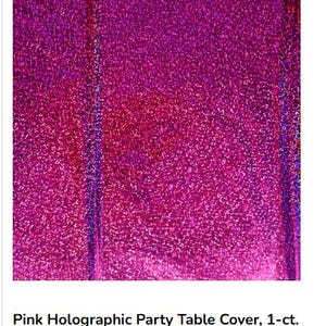 May include: Pink holographic party table cover. The cover has a shiny, textured surface with a pink color. The image shows the party table cover with a close-up view of the material.