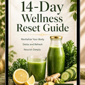 May include: A digital tablet displays a wellness guide titled "14-Day Wellness Reset Guide." The image features a green smoothie in a glass and bottle, with lemon slices, ginger, and cucumber. The guide promises to revitalize, detox, and nourish.
