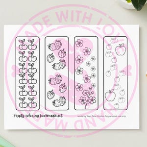 May include: A set of four rectangular bookmarks with a pink background and black outlines. Each bookmark features a different fruit design: cherries, strawberries, flowers, and apples. The text "Fruity coloring bookmark set" is at the bottom.