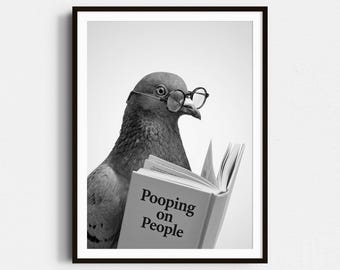 May include: Black and white framed print featuring a pigeon wearing small round glasses, reading a book titled "Pooping on People". The pigeon is in the center of the image, with a plain white background.