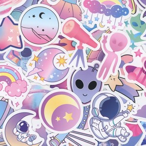 May include: A collection of space-themed stickers featuring pastel-colored illustrations of astronauts, planets, rockets, stars, telescopes, moons, and aliens. The designs include various celestial bodies, cosmic motifs, and whimsical space gear.
