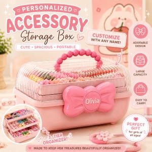 May include: A pink plastic accessory storage box featuring a clear, ribbed lid and a beaded handle. The front displays a large pink bow with the name Olivia printed in the centre. The box includes a three-tier organiser tray for small items.