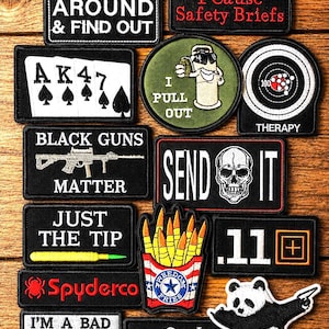 May include: A collection of rectangular, circular, and shaped embroidered morale patches featuring various graphic designs, including text such as FUCK AROUND & FIND OUT, WARNING I CAUSE SAFETY BRIEFS, SEND IT, and I PULL OUT, alongside illustrations of playing cards, a skull, a panda, and fries.