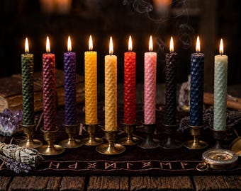 May include: Ten tall, cylindrical beeswax candles with a textured honeycomb pattern, each in a different color including green, red, purple, yellow, orange, pink, black, blue, and light green, standing in individual brass candle holders.