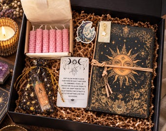 May include: A black gift box containing a black journal with a gold sun illustration, a small box of six pink honeycomb candles, a star-patterned pouch with a glass vial, a moon sticker, a star charm, and a card with printed text.