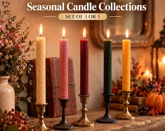 May include: Five tall, textured, honeycomb-patterned taper candles in cream, pink, dark red, dark green, and yellow, each lit and standing in individual metal candle holders. Text reads: LIFEARIS Seasonal Candle Collections SET OF 3 OR 5.