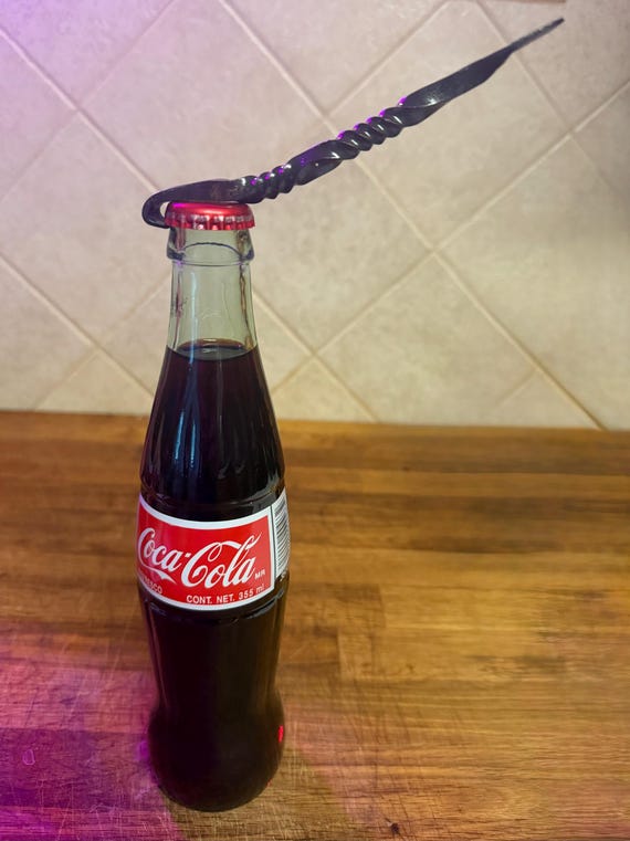 Actually hammer-forged by a blacksmith — the visible forge marks and raw iron texture make it a functional piece of craft you'll actually use every beer night.