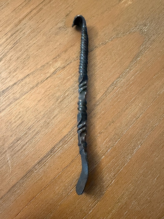 A blacksmith actually hammered this from raw steel — the organic shape and hammer marks make every one subtly one-of-a-kind in a way no factory can fake.
