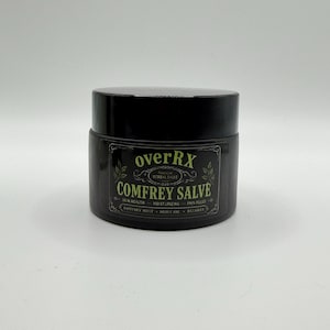 May include: A black jar of Comfrey Salve with a black lid. The label reads "overRx Herbal Salve" and lists "Skin Health, Moisturizing, Pain Relief". Ingredients include Comfrey Root, Olive Oil, and Beeswax.