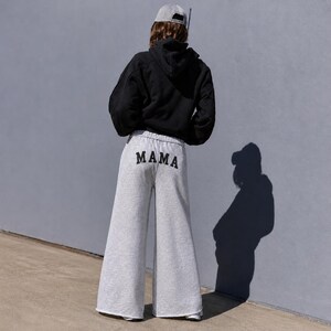 Mama sweatpants wide leg custom mom gift outfit, white mama sweatpants flat lay relaxed fit, cozy mom loungewear pants for everyday wear, soft cotton sweatpants for moms gift, minimalist neutral aesthetic clothing, comfy stay at home mom outfit idea, casual lounge pants for moms soft fabric