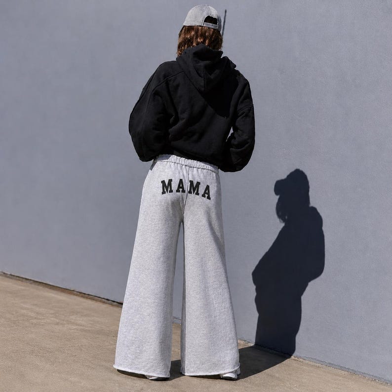 Mama sweatpants wide leg custom mom gift outfit, white mama sweatpants flat lay relaxed fit, cozy mom loungewear pants for everyday wear, soft cotton sweatpants for moms gift, minimalist neutral aesthetic clothing, comfy stay at home mom outfit idea, casual lounge pants for moms soft fabric