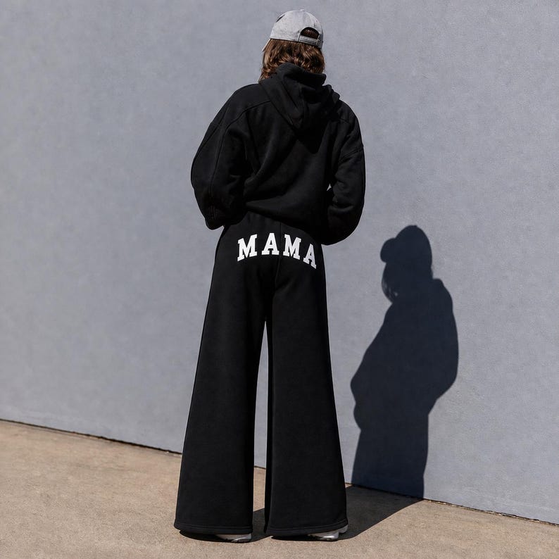 Mama sweatpants back view relaxed wide leg fit, custom mama pants with text on back, unique gift idea for moms, cozy everyday mom outfit, soft fleece sweatpants aesthetic neutral loungewear, comfortable mom sweatsuit set modern minimal style, stay at home mom outfit comfy and cute