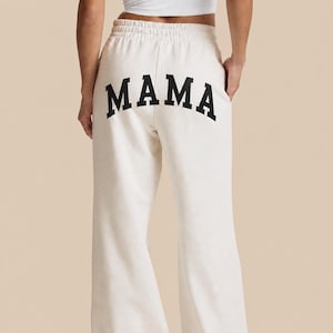 Mama sweatpants wide leg relaxed fit in white cozy mom loungewear outfit, custom mama pants for everyday wear, soft cotton lounge pants for moms, comfortable stay at home mom outfit aesthetic, minimal modern mom style, postpartum comfy outfit idea, gift for new mom, cozy matching sweatsuit for moms