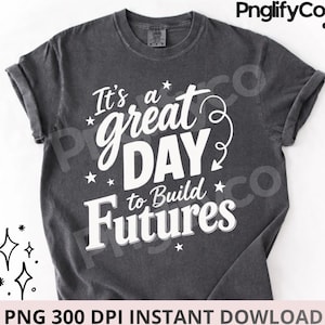 Könnte beinhalten: Ein anthrazitfarbenes Kurzarm-T-Shirt mit weißem Aufdruck It's a great DAY to Build Futures, verziert mit kleinen Sternen und einem geschwungenen Pfeil. Das Shirt verfügt über einen Rundhalsausschnitt und eine verwaschene Vintage-Optik.