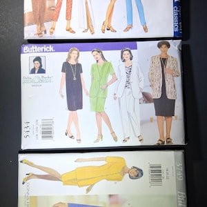May include: Three vintage Butterick sewing pattern envelopes. The top envelope is labeled "5585 Butterick classics" and features illustrations of women in various dresses and pantsuits. The middle envelope is "5434" and the bottom is "3749".