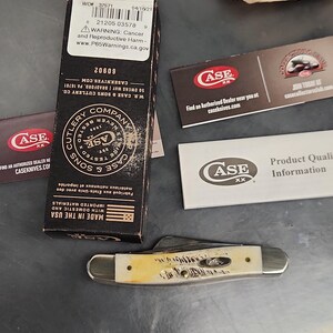 May include: A folding pocket knife with a textured cream-colored handle and silver metal bolsters, accompanied by its original black cardboard packaging box, a Case XX brand information card, and a collector club promotional insert.