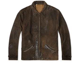 May include: A dark brown leather jacket featuring a pointed collar, a full-length front zipper closure, and two slanted welt pockets at the waist. The jacket has long sleeves with adjustable buttoned cuffs and a tan interior lining.