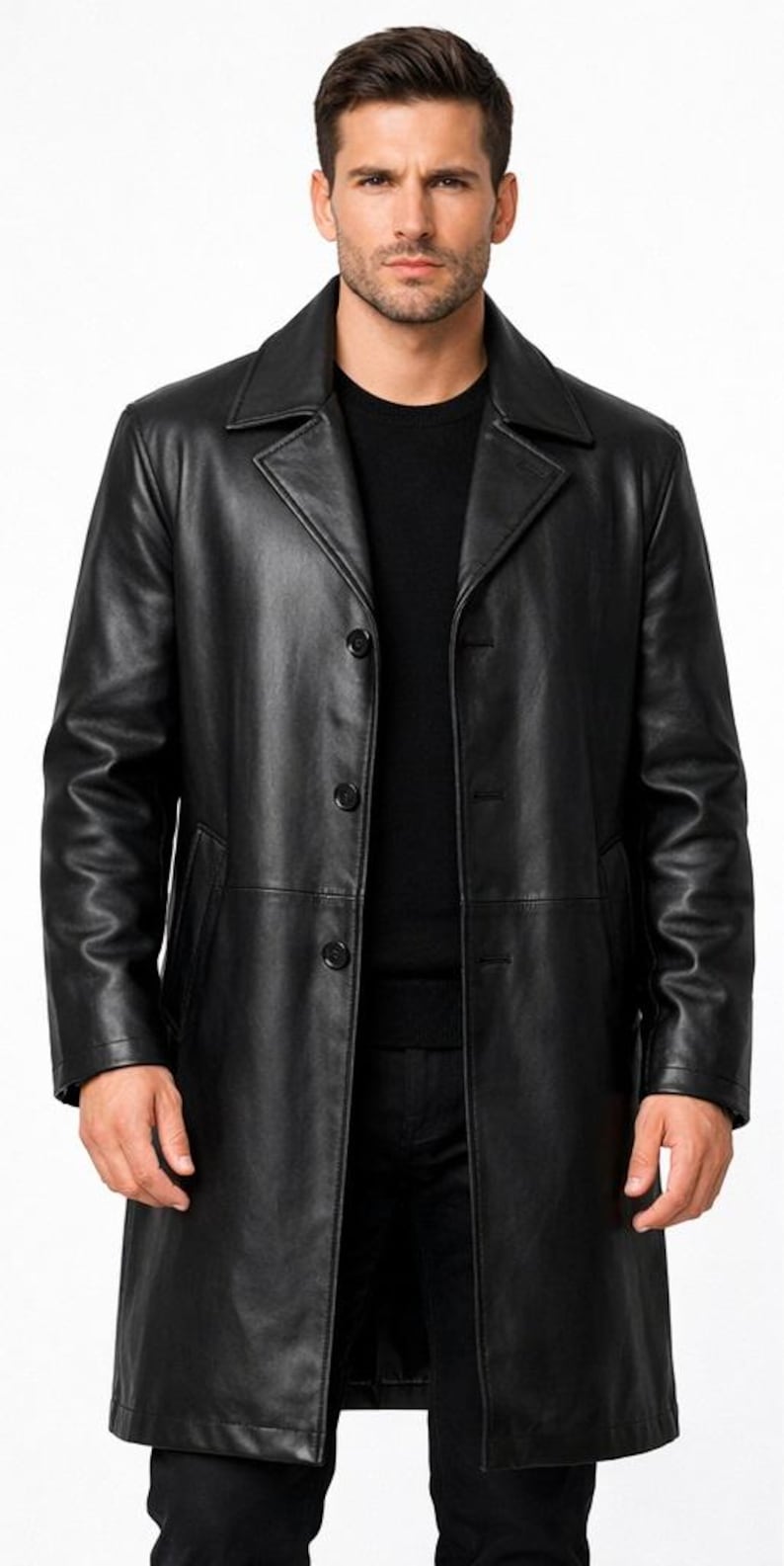 May include: A black leather overcoat with a classic design. The coat features a notched collar, three-button closure, and two front pockets. The long coat is worn over a black sweater and black pants.