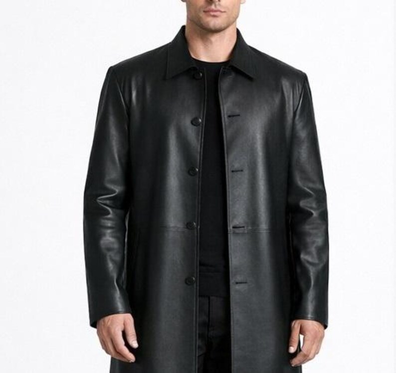 May include: A black leather coat with a button-up front and a collared neckline. The coat is long, reaching below the knees, and has a classic, tailored design. The coat is made of a smooth, shiny leather material.