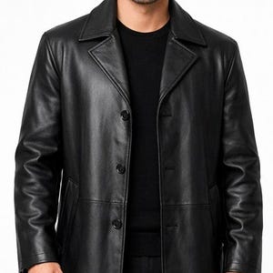 May include: A black leather coat with a classic design. The coat features a notched collar, three buttons, and a tailored fit. The coat is a solid black color and appears to be made of high-quality leather.