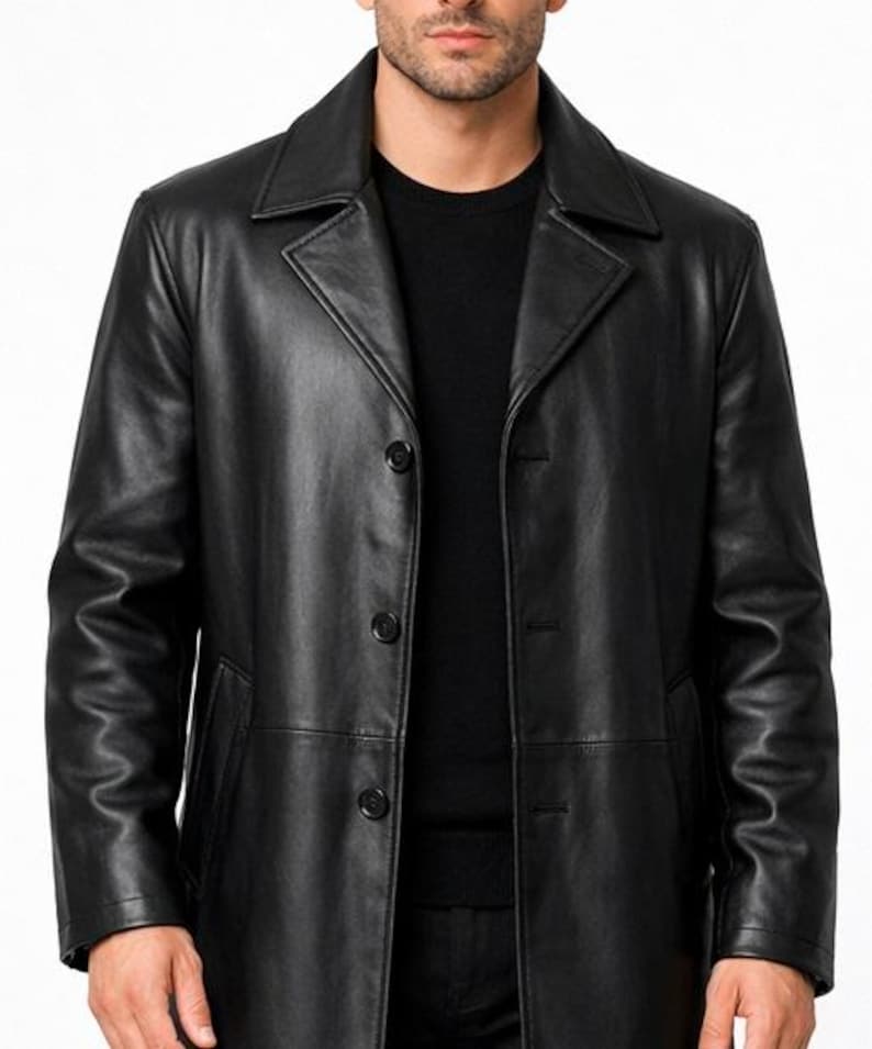 May include: A black leather coat with a classic design. The coat features a notched collar, three buttons, and a tailored fit. The coat is a solid black color and appears to be made of high-quality leather.