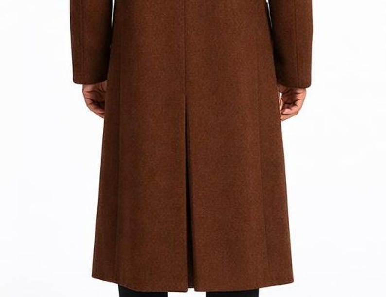 May include: A long, brown wool coat with a classic design. The coat features a tailored fit, long sleeves, and a split back. The coat is made of a textured fabric and is suitable for cold weather. The coat is a versatile piece of outerwear.
