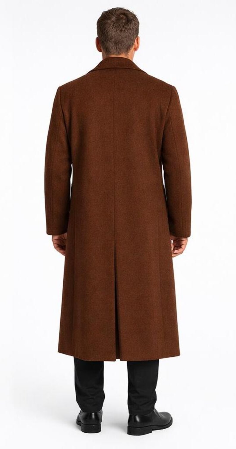 May include: A long, brown overcoat with a classic design. The coat is made of a textured fabric and features a notched collar and a single vent in the back. The coat is worn over black pants and shoes.