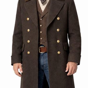 May include: A dark brown wool duster coat featuring a double-breasted front with gold-toned buttons, a contrasting velvet collar, a brown vest, a patterned neckerchief, blue denim jeans, a brown leather belt, and a matching dark brown cowboy hat.