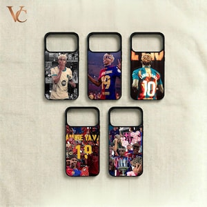 May include: Black phone cases with various soccer player designs. Each case features a different player in action, with vibrant colors and detailed imagery. The cases are arranged on a neutral background.