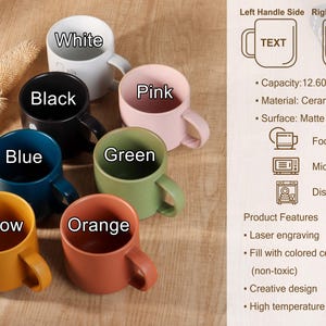 May include: A collection of ceramic mugs in various colors: white, black, blue, yellow, orange, green, and pink. Each mug has a handle and is labeled with its color. The mugs are food, microwave, and dishwasher safe.