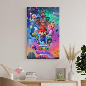 May include: A framed canvas print of "The Super Mario Galaxy Movie" featuring Mario, Luigi, Princess Peach, Bowser, and other characters. The artwork has a vibrant, colorful design with a space theme.