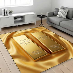 May include: A rectangular rug featuring two gold bars with the text "FINE GOLD 999.9" and "NET WT 1000g" printed on them. The rug has a golden, silky background and is placed in a living room setting.
