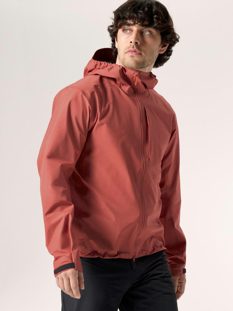 Puede incluir: Chaqueta con capucha de color &oacute;xido con cremallera completa. La chaqueta tiene un dise&ntilde;o estilizado con un peque&ntilde;o bolsillo en el pecho y detalles negros en los pu&ntilde;os. El modelo lleva pantalones negros.