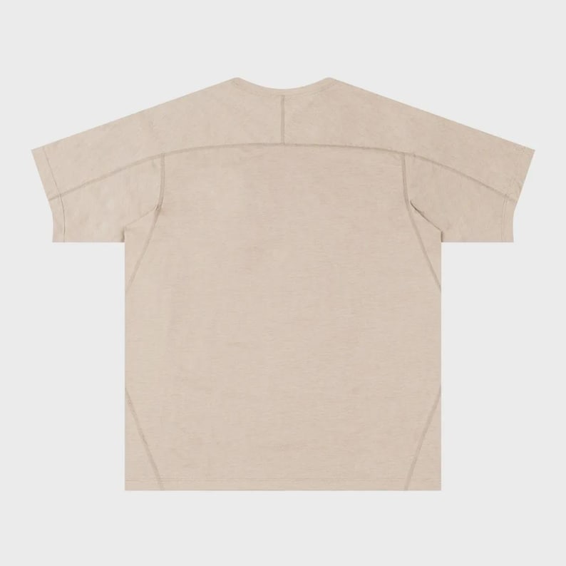 May include: A beige short-sleeved t-shirt with visible stitching details. The shirt has a crew neck and a relaxed fit. The seams are reinforced with a contrasting thread, adding a subtle design element. The fabric appears lightweight and breathable.