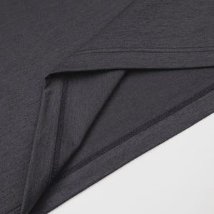 May include: Close-up of a dark gray t-shirt, showcasing the neckline and a portion of the fabric. The stitching is visible along the seams, highlighting the garment's construction. The fabric has a subtle texture.