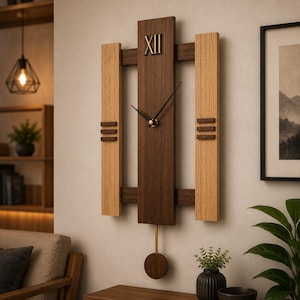 May include: A rectangular wall clock featuring a central dark brown wood panel with a gold Roman numeral XII at the top, flanked by two lighter oak wood vertical panels with three horizontal dark brown slats on each side, and a gold pendulum.