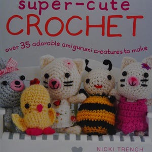 May include: A handmade wooden sign with the word "Welcome" in a whimsical font. The sign is painted white with a distressed finish, and features a floral design in pinks and greens. It measures approximately 30 cm wide.