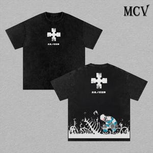 May include: Black t-shirts with a white cross design and Japanese text. One shirt displays the front, the other the back, featuring a character illustration. The shirts have a vintage, washed look.