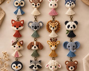 May include: A collection of sixteen macrame animal keychains featuring an owl, deer, rabbit, husky, fox, koala, lion, panda, cat, dog, giraffe, elephant, penguin, raccoon, sheep, and bear, each with a metal lobster clasp and a cotton tassel.
