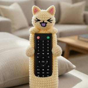 May include: A white ceramic mug with a black handle and the text "But First, Coffee" in a black, handwritten-style font. The mug is on a white surface.