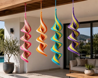 May include: Four colorful, spiral-shaped crochet ornaments hanging from a wooden beam. The ornaments feature pink, orange, blue, and purple color schemes with white accents. The crochet work creates a textured, decorative effect, suitable for outdoor or indoor decor.