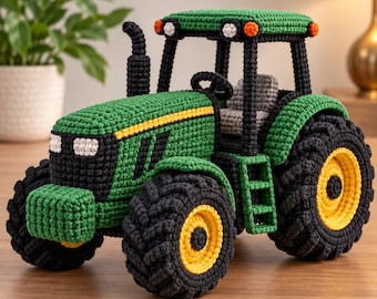 May include: A handcrafted crochet tractor featuring a green body with black accents, a yellow stripe, and large black tires with yellow centers. The vehicle includes a grey seat, a black exhaust pipe, and small orange and white lights on the roof.