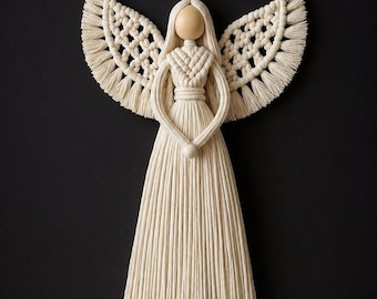 May include: A handcrafted macrame angel with a wooden head and cream-colored cotton cord. The angel has outstretched wings, a flowing dress, and clasped hands. The background is solid black.
