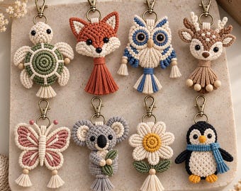 May include: A collection of eight macrame keychains featuring animal and floral designs including a turtle, fox, owl, deer, butterfly, koala, daisy, and penguin. Each piece is crafted with knotted cord, small wooden beads, and bronze-toned metal clasps.