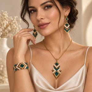 May include: A jewelry set consisting of a necklace, a bracelet, and drop earrings. Each piece features a geometric pattern made of small beads in shades of teal, white, and metallic gold, arranged in a diamond-shaped motif on a gold chain.