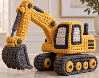 May include: A crocheted toy excavator in yellow and dark gray yarn. The construction vehicle features a movable boom arm, a large dark gray bucket, a cab with white windows, and tracked wheels with yellow circular accents on the sides.