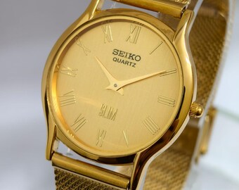 Reloj Seiko Slim Tank de cuarzo vintage – esfera dorada con números romanos – Restaurado – Reloj clásico unisex
