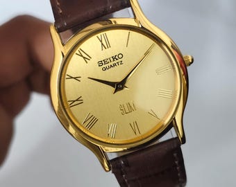 Reloj Seiko Slim Tank de cuarzo vintage – esfera dorada con números romanos – Restaurado – Reloj clásico unisex