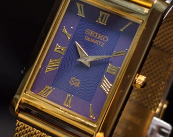 Reloj de vestir clásico unisex Seiko Slim Tank vintage con esfera morada y tono dorado, restaurado.