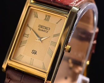 Reloj Seiko Slim Tank de cuarzo vintage – esfera dorada, tono dorado, reacondicionado, unisex.